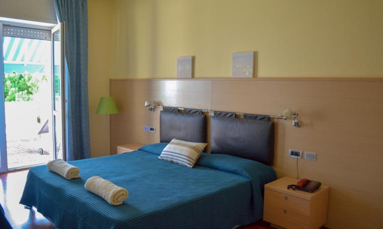 Bright bedroom with double bed and terrace.
