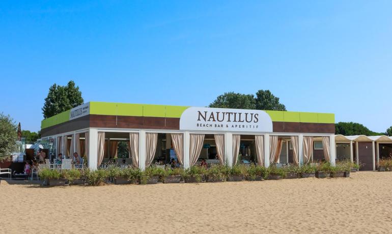 Sunny beach with cozy bar, a vibe of relaxation and vacation.