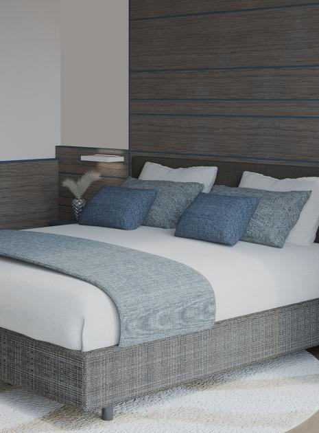 Elegant room with cozy bed and tidy clothes, relaxing atmosphere.