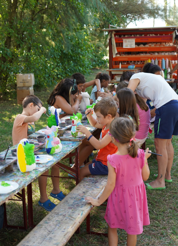 Children celebrate with a crocodile costume and certificates.